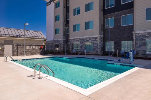 a swimming pool in front of a building at Residence Inn by Marriott Charlotte Steele Creek in Charlotte
