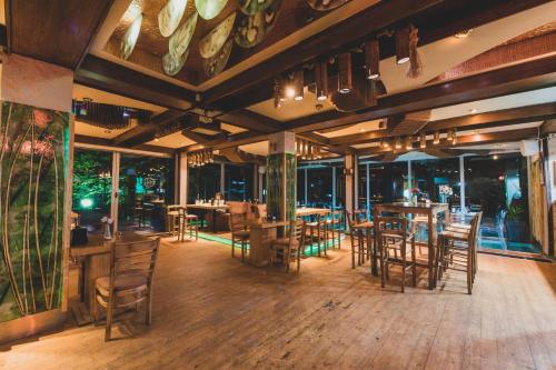 a restaurant with wooden tables and chairs and windows at Euro Hotel Gradche in Kočani