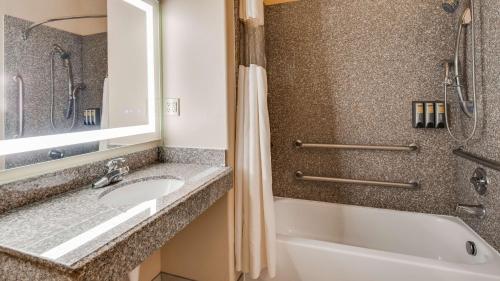 a bathroom with a sink and a tub and a shower at Best Western Plus Battleground Inn & Suites in Battle Ground
