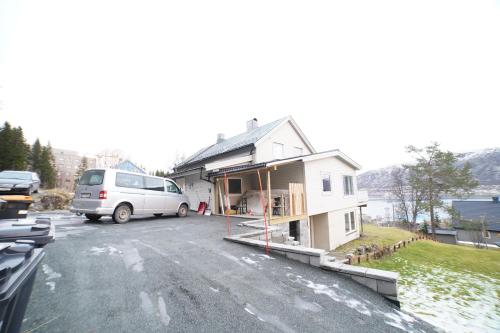 a van parked in front of a house at Mary Rooms in Tromsø
