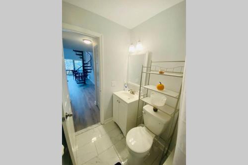 a white bathroom with a toilet and a sink at Brand New! MountainCreek SlopeSide Condo,Golf,&Spa in Sand Hills