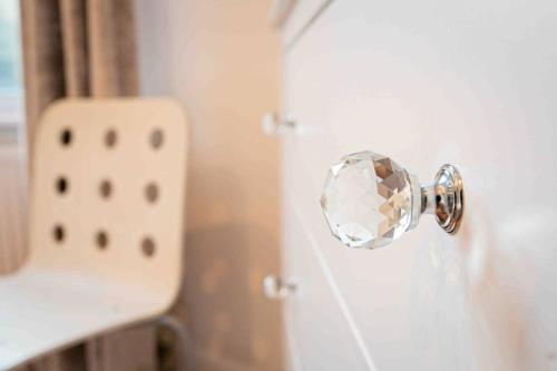 a door knob with a diamond on a white door at Large 3 Bedroom modern apartment close to central London in Finchley