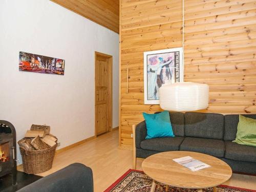 a living room with a couch and a table at Peaceful Holiday Home in Jutland with Sauna in Ebeltoft