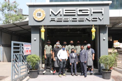 a group of men standing outside of a building at Megh Residency Navi Mumbai in Navi Mumbai