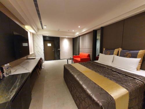 a hotel room with a large bed and a television at Sun Motel in Kaohsiung