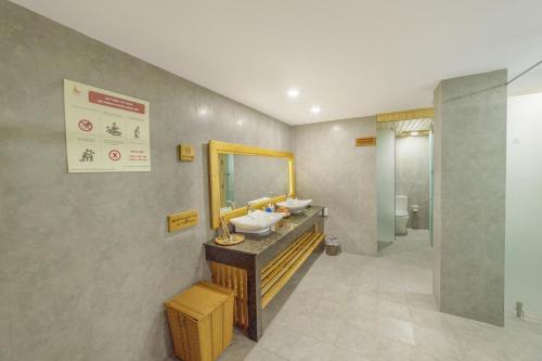 a bathroom with two sinks and a mirror at Lake View Hotel in Quy Nhon