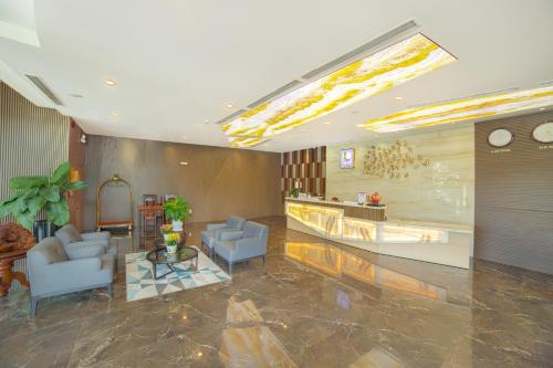a lobby with two chairs and a table in a building at Lake View Hotel in Quy Nhon