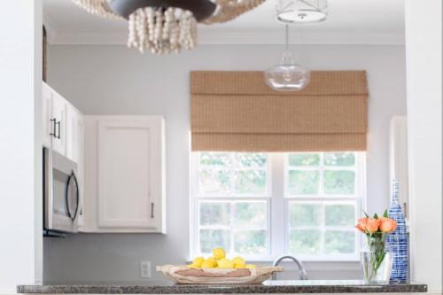 a kitchen with a bowl of fruit and a window at Falling Moss in Porcher Bluff