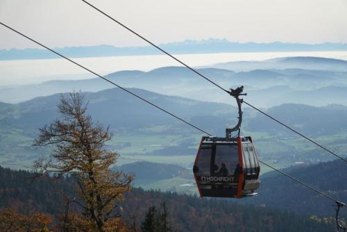 a gondola ride over a valley in the mountains at Apartmán Relax Nová Pec Lipno in Nová Pec