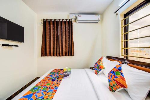 a small room with a bed and a window at Transit Dorms - A Backpackers Inn & Hostel in Bangalore