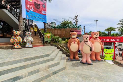 a group of teddy bears are standing on the steps at Access Inn Pattaya in Pattaya Central