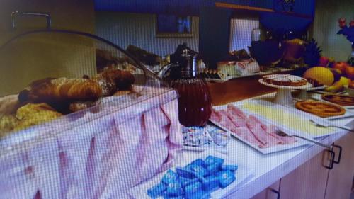 a buffet with pastries and other foods on a table at Hotel Cristallo in Udine