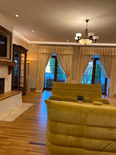 a large living room with a couch and a fireplace at ApartamentS in Râşnov