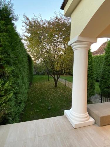 a white column on a porch with a yard at ApartamentS in Râşnov