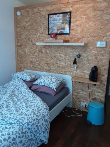 a bedroom with a bed and a brick wall at Au 49 in Spa