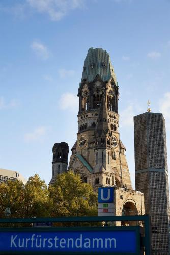 an old building with a clock tower in a city at Dorint Kurfürstendamm Berlin in Berlin