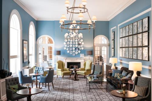 a living room filled with furniture and a fireplace at Queens Hotel Cheltenham in Cheltenham