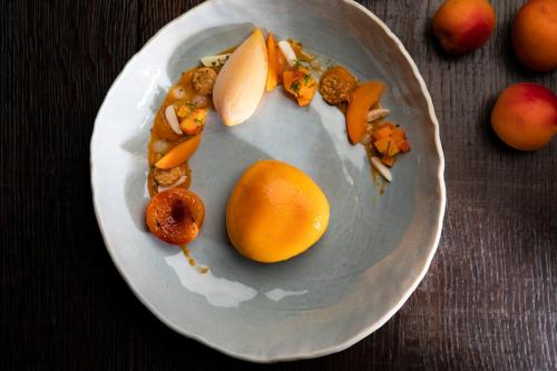 a plate of food with fruits and vegetables on a table at La Ferme Saint Simeon Spa - Relais & Chateaux in Honfleur