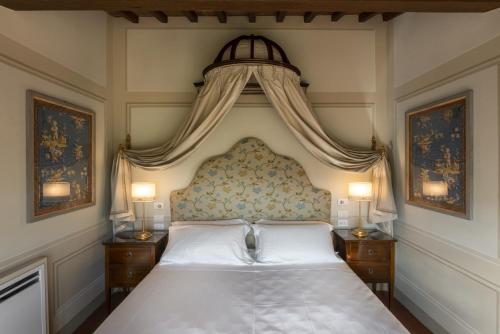 a bedroom with a large bed with a canopy at Torre a Cona Wine Estate in Florence