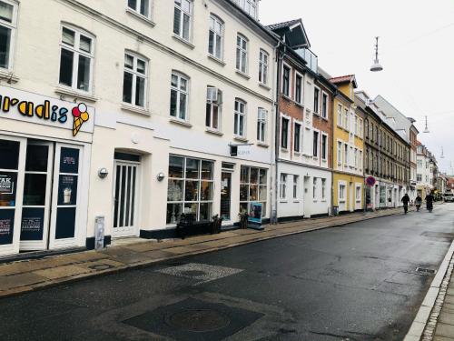an empty street with buildings on the side of the road at aday - Reberbansgade Central Apartment in Aalborg
