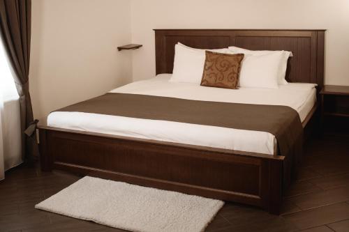 a bedroom with a large bed with white sheets at Ekaterinoslav in Dnipro