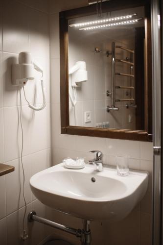 a bathroom with a white sink and a mirror at Ekaterinoslav in Dnipro