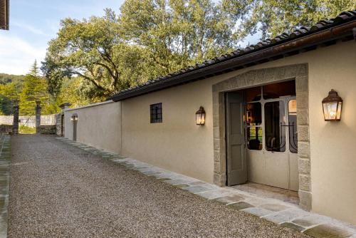 a building with a door and a walkway at Torre a Cona Wine Estate in Florence