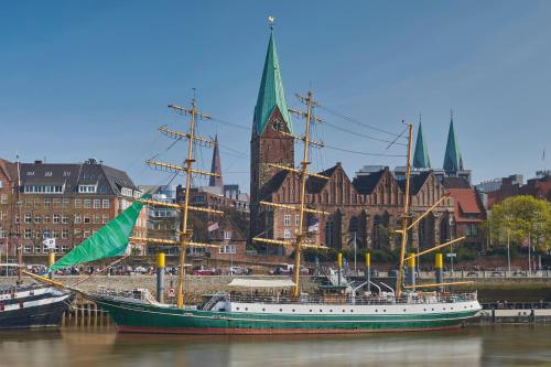 a boat sitting in the water in front of a city at Alexander von Humboldt - Das Schiff in Bremen