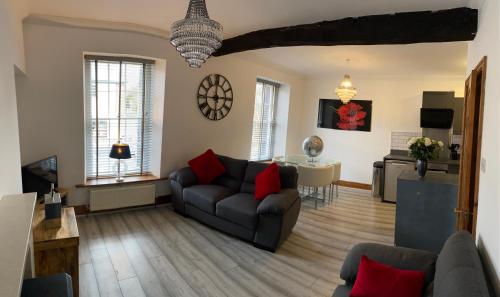 a living room with a couch and a table at Crown and Cushion Appleby in Appleby