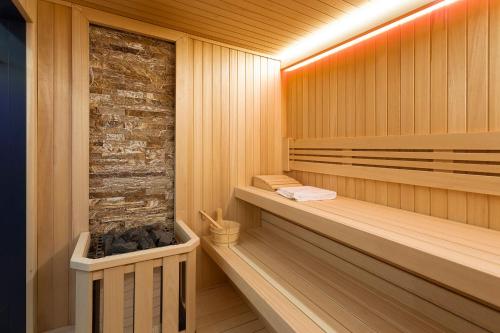 a bathroom with a stone wall and a wooden floor at Vital Hotel Fulya Istanbul Sisli in Istanbul