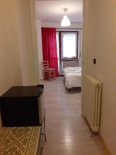a room with a bedroom with a bed and a window at La Casetta Del Dahu in Limone Piemonte
