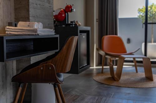 a living room with two chairs and a desk at Sleeping Inn in Hualien City