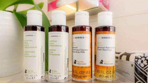 four bottles of hair products sitting on a shelf at Alexander Beach Hotel & Spa in Alexandroupoli