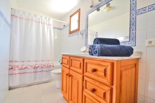 a bathroom with a sink and a toilet and a mirror at Casa de Campo con Encanto in Pollença