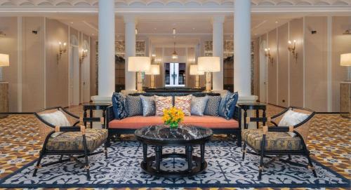 a lobby with a couch and two chairs and a table at Hyatt Regency Phnom Penh in Phnom Penh
