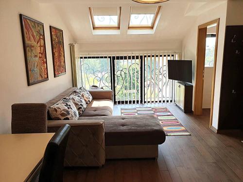 a living room with a couch and a tv at Alo Alo Apartman 4 in Kruševac