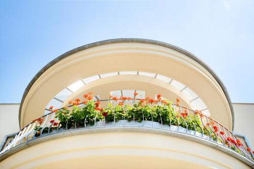 a balcony with plants on top of a building at Vila EVA in Luhačovice