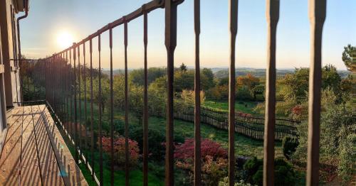 a balcony with a view of a garden through a fence at Vikendovka Korce in Dubá
