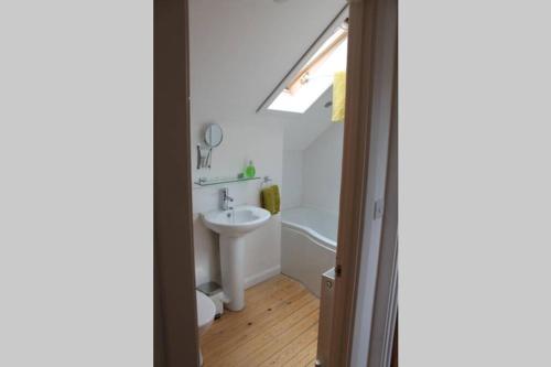 a bathroom with a sink and a toilet and a window at The Barn @ Mill Haven Place, 3 bedroom cottage in Haverfordwest