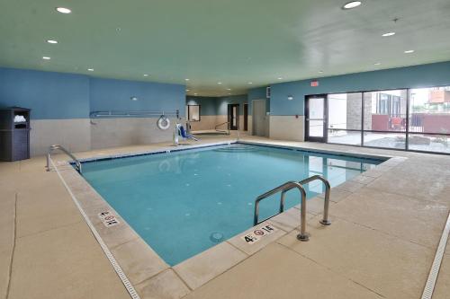 a large swimming pool in a building at Holiday Inn Express & Suites - Albuquerque East by IHG in Albuquerque
