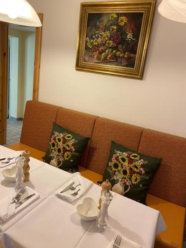 a table in a restaurant with a painting on the wall at Arena Stadt München in Munich