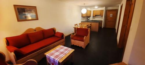 a living room with a couch and a table at Appartement et studio, Val d'illiez in Val dʼIlliez