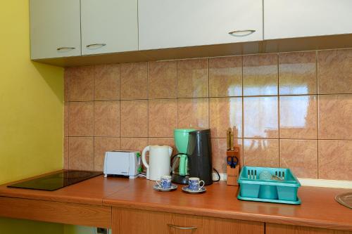 a kitchen counter with two coffee makers on it at Evridika Apartments in Nesebar