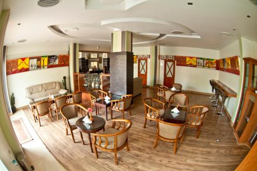 a restaurant with tables and chairs in a room at Paramount Tower in Kozhikode