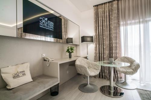 a room with a table and two chairs and a phone at Hotel Eden Garden Spa in Câmpulung Moldovenesc