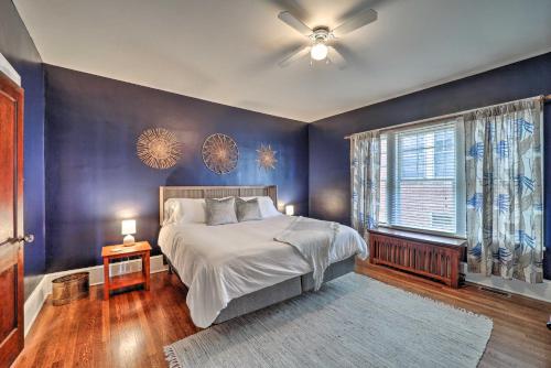 a bedroom with a bed and a blue wall at Bristol Bungalow Less Than 1 Mi to Country Music Museum in Bristol
