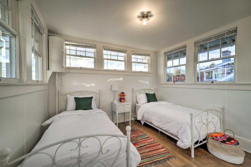 two beds in a small room with windows at Bristol Bungalow Less Than 1 Mi to Country Music Museum in Bristol