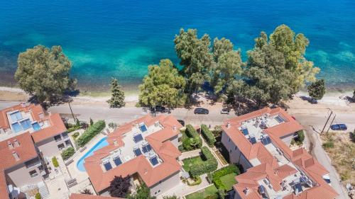 an aerial view of a house in front of the ocean at Meliti Waterfront Suites in Karavomylos