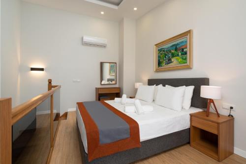 Postel nebo postele na pokoji v ubytování Veranda Suites