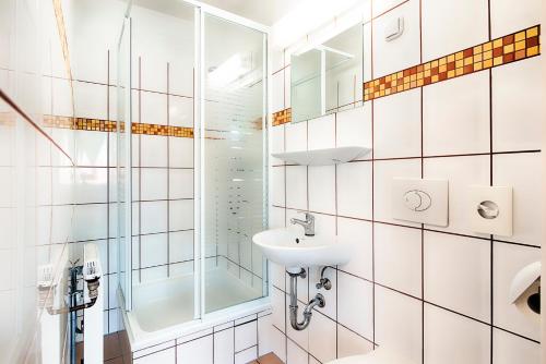 a bathroom with a sink and a shower at Hotel B1 in Berlin